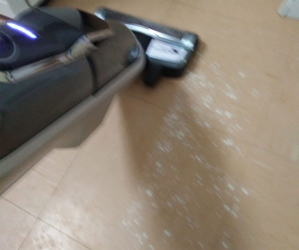 Using the Bosch Athlet Ultimate Vacuum Cleaner to clean flour off the kitchen floor.