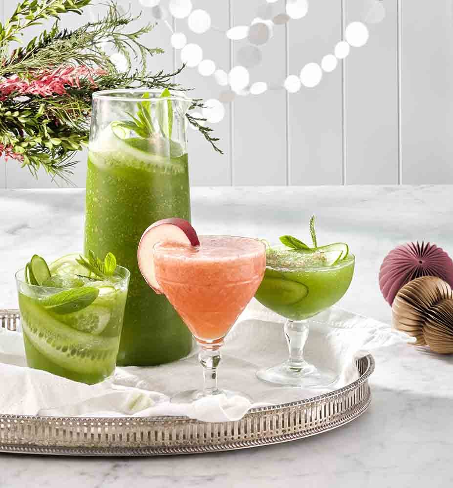 Cucumber & Lime Gin Frappé and White Peach Aperol Spritz in glasses.