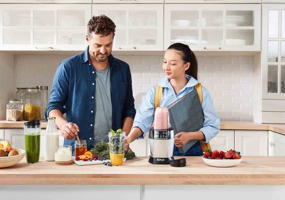 People using the The Nutri Ninja Auto IQ Blender to create a variety of juice and smoothie recipes.