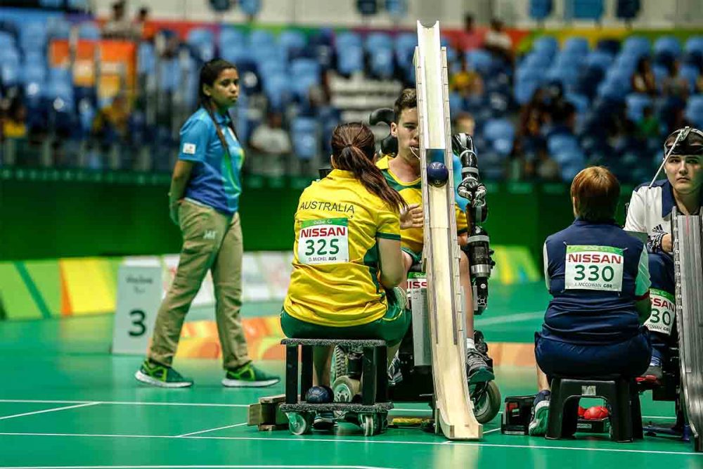 Dan Michel playing boccia for Australia with fellow athlete next to him..
