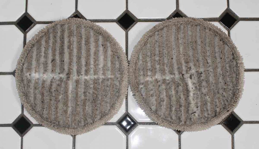 Dirty cleaning pads after mopping the bathroom floor with the Bissell SpinWave Cordless Mop.