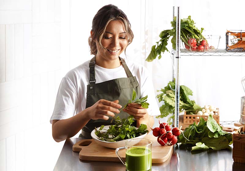 Dorothy Lee creating a raw vegetable plate.