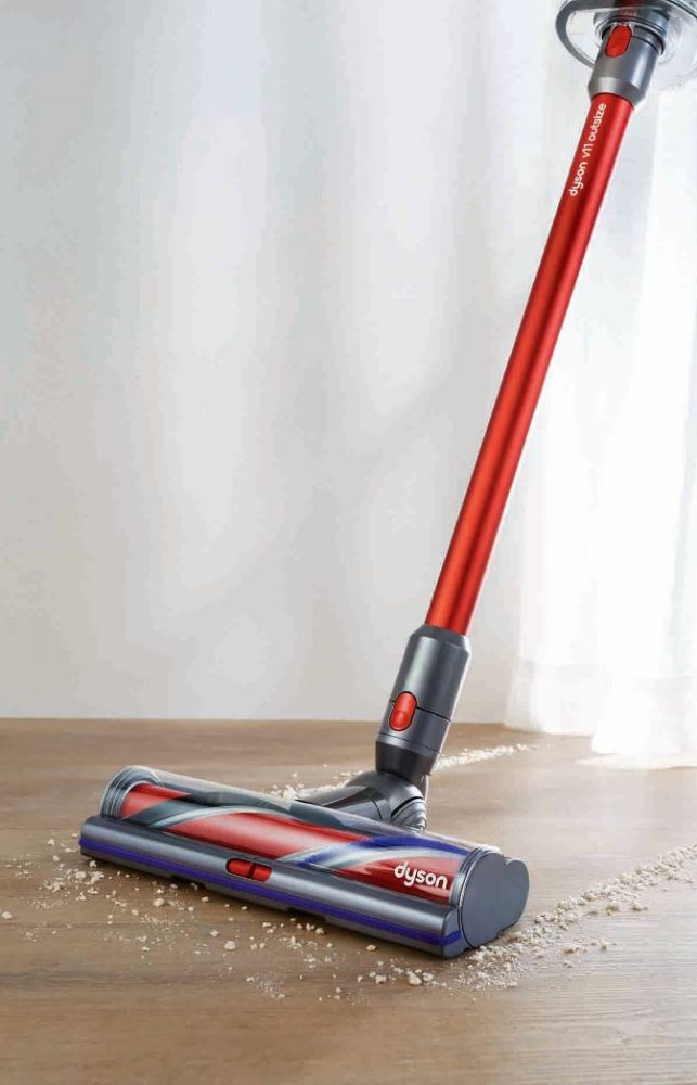 The Dyson V11 Outsize Cordless Vacuum cleaning floorboards with the wide High Toque XL cleaner head attached.