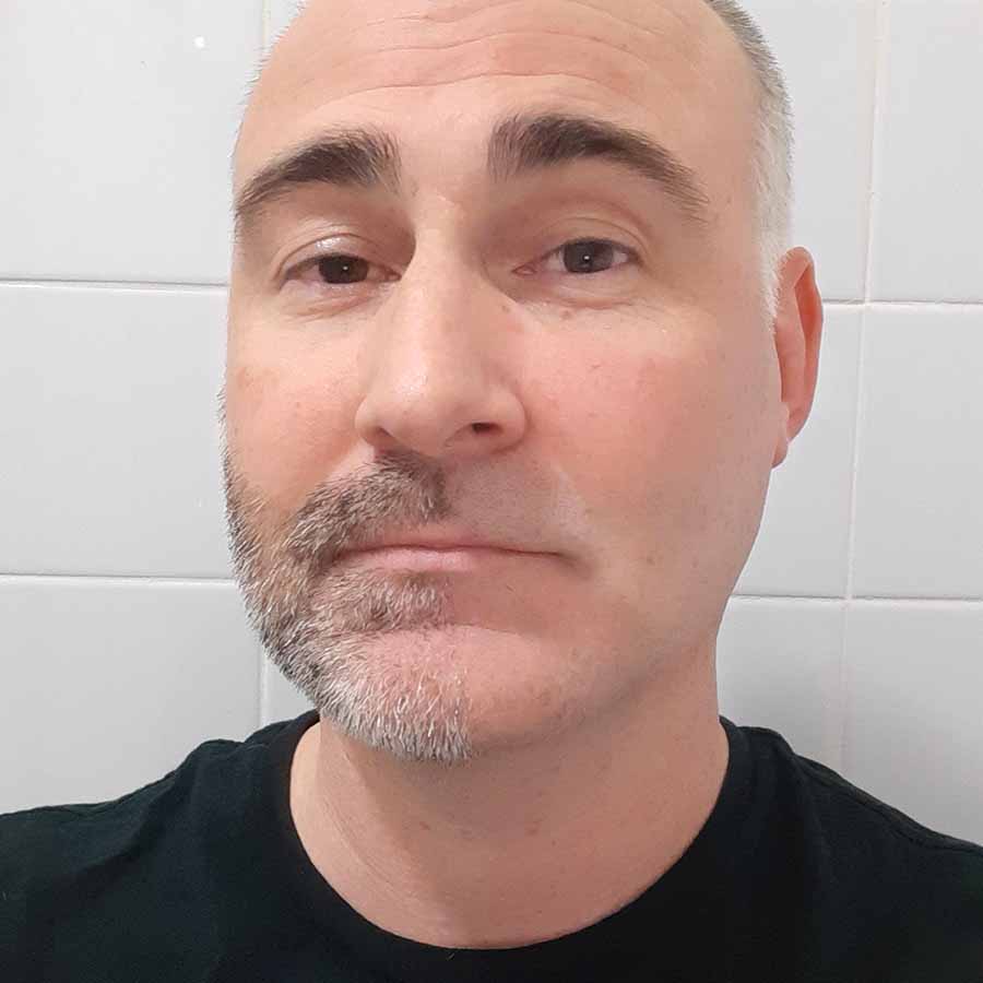 Our Philips Series 9000 reviewer with half his face shaved.