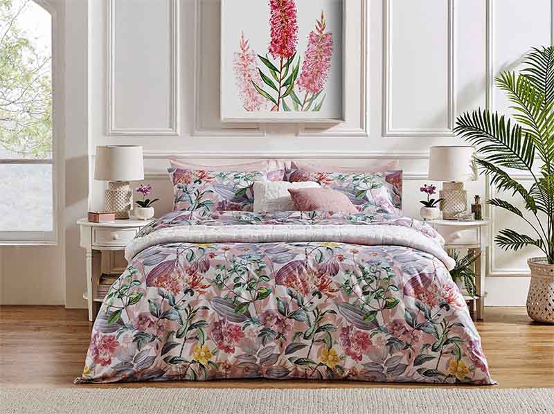 The Inez Quilt Cover Set on a bed with a white/cream wall behind it.