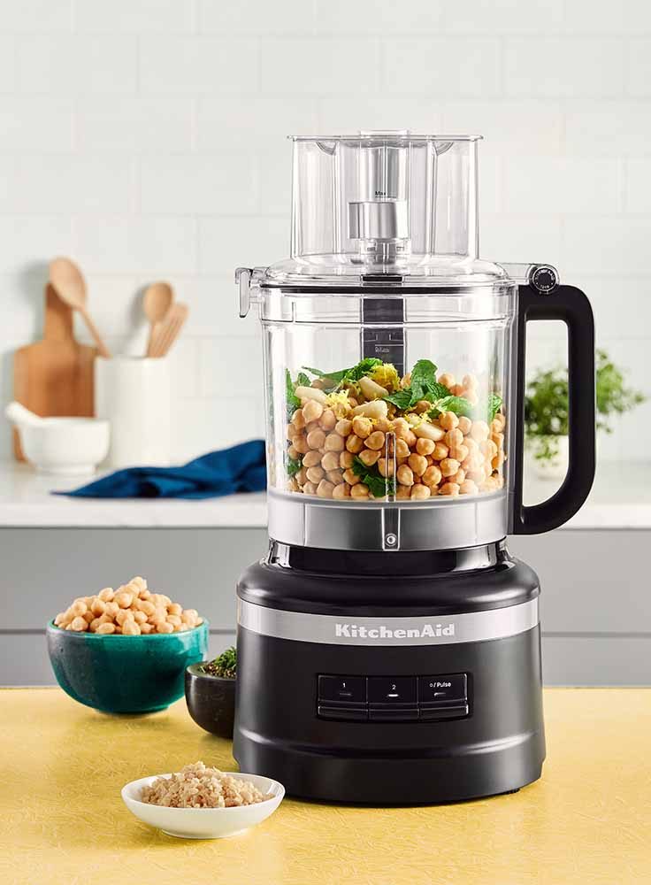 The Kitchen Aid Food Processor with chickpeas inside.