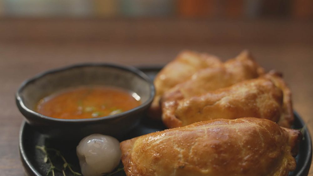 Quail + Nduja Empanadas on a plate.