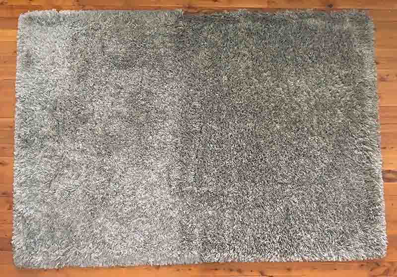 A floor mat that has been cleaned with the Dyson V11 Outsize Cordless Vacuum.
