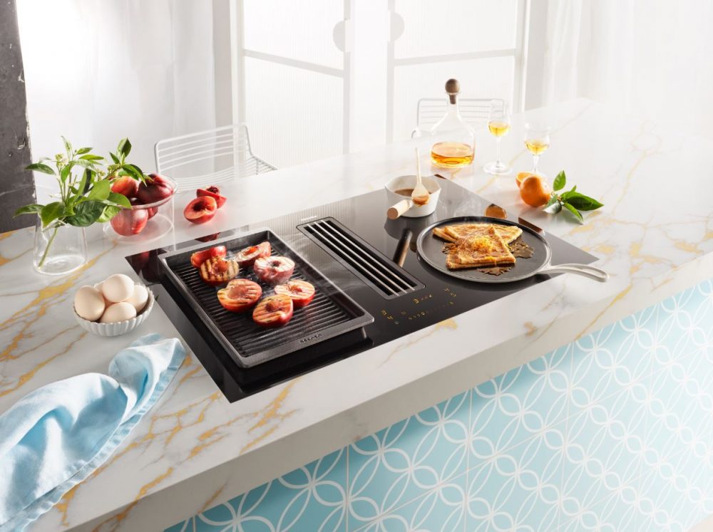 A recipe cooking on the Miele 4-Zone Induction Cooktop with Integrated Vapour Extraction.