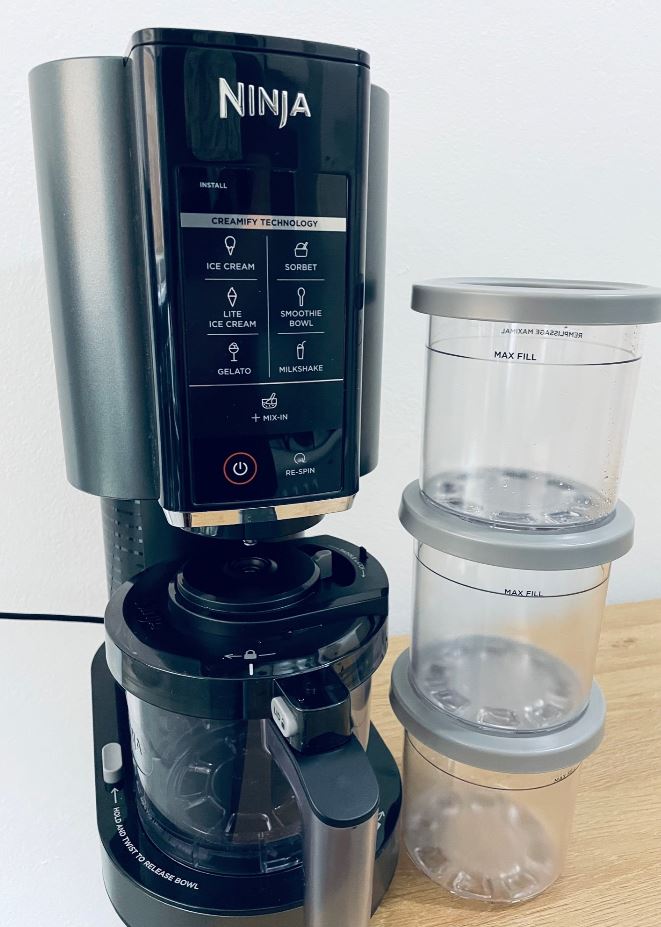 The Ninja Creami Ice Cream Maker and three included Pints.