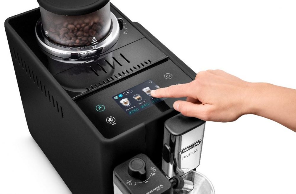 A person operating the De'Longhi Rivelia Automatic Coffee Machine.