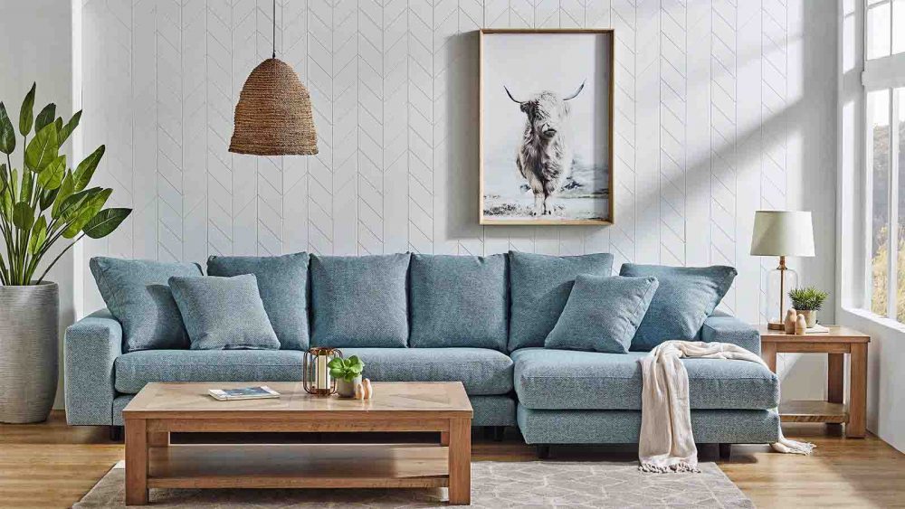 The Plaza 3.5-Seater Fabric Sofa with Chaise in a lounge room.