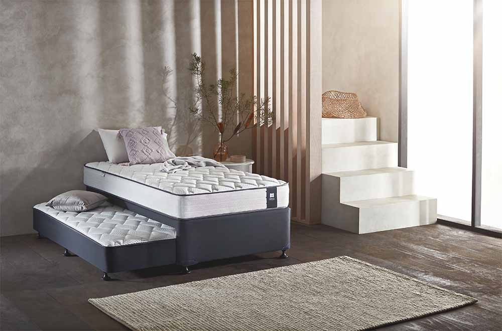 The Sealy Omni 3-Piece Single Trundle Set in a guest bedroom.