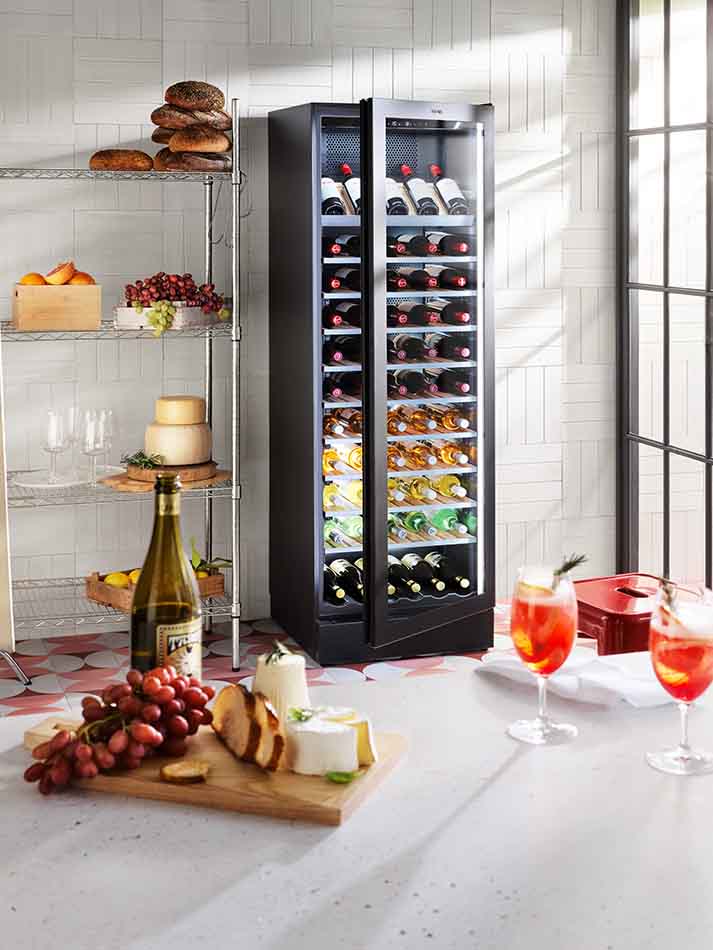 A Vintec Premium 126 Bottle Right Hinge Multi-Temp Wine Cellar stocked with wine.